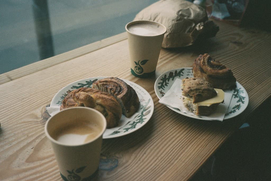 Coffee and pastries on wooden table