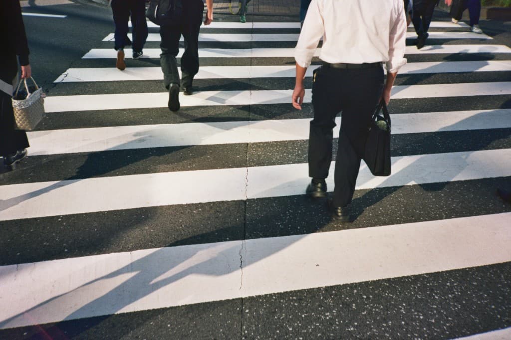 Pedestrians on a zebra crossing, low angle with long shadows